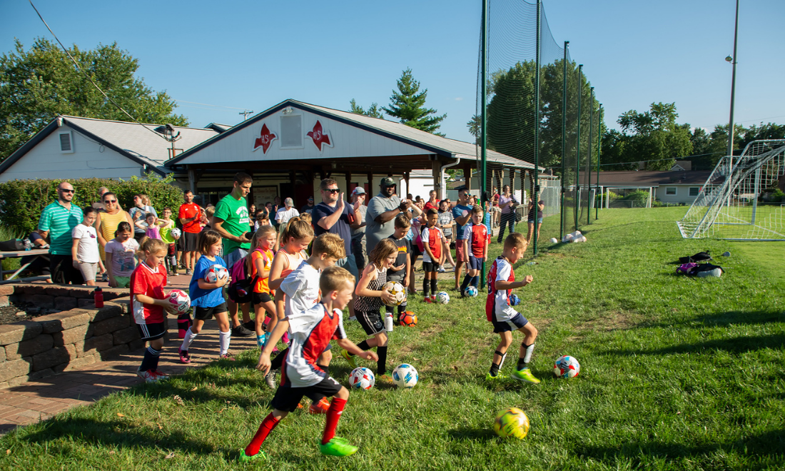 Children rush to play at Father Frey Athletic Field